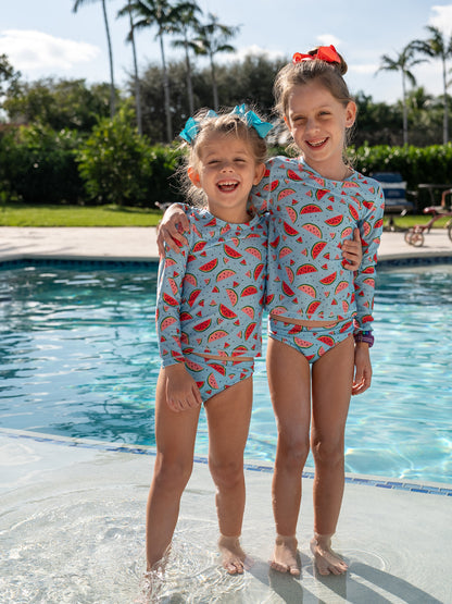 Girls wearing Isla & Ray matching swimwear in watermelon print