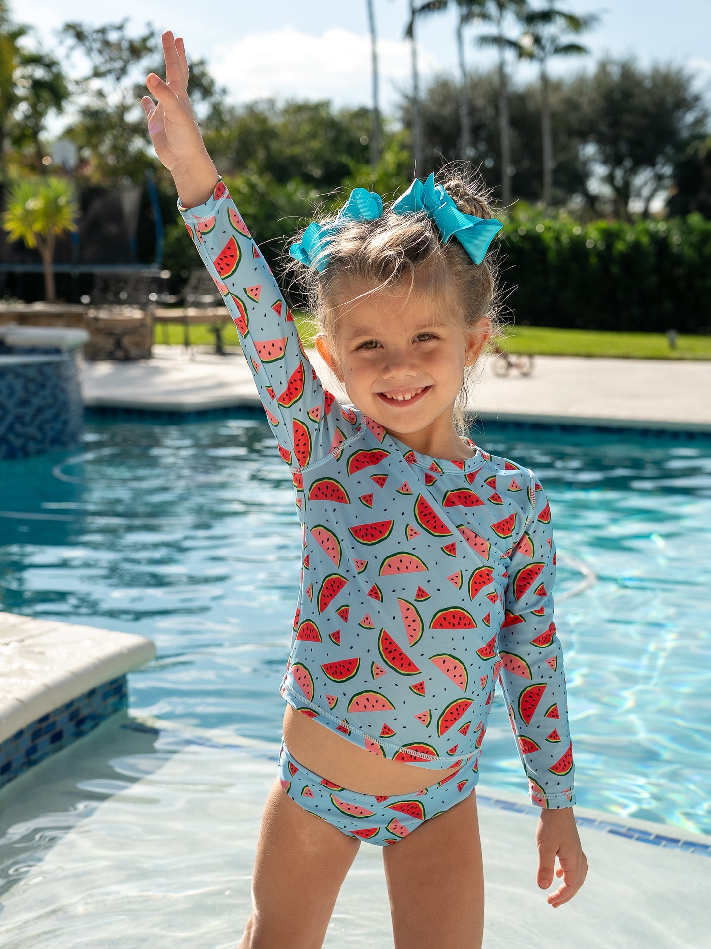 Girl in Isla & Ray watermelon print rash guard swimsuit