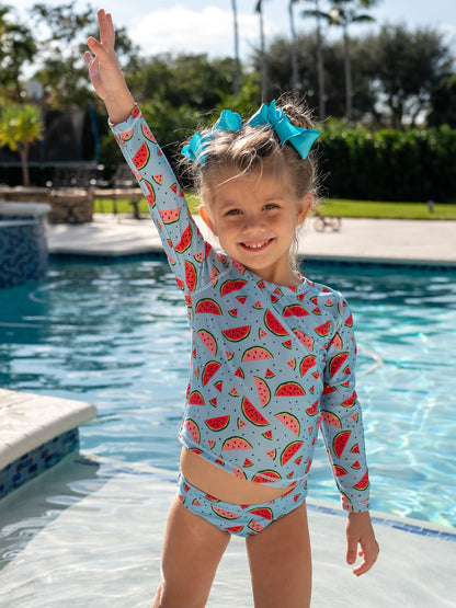 Girl in Isla & Ray watermelon print rash guard swimsuit